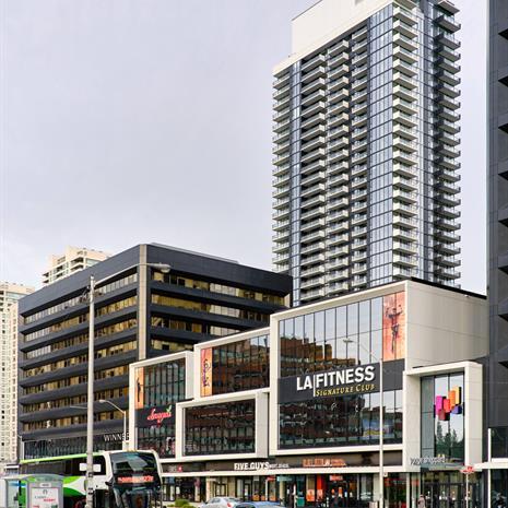 Rendering of two buildings: a black commercial midrise with a BMO bank at the base, and a residential tower