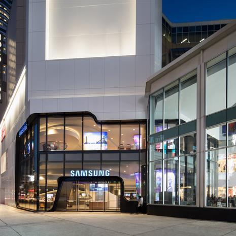 exterior of the Samsung store from the sidewalk in front of the Eaton Centre at dusk