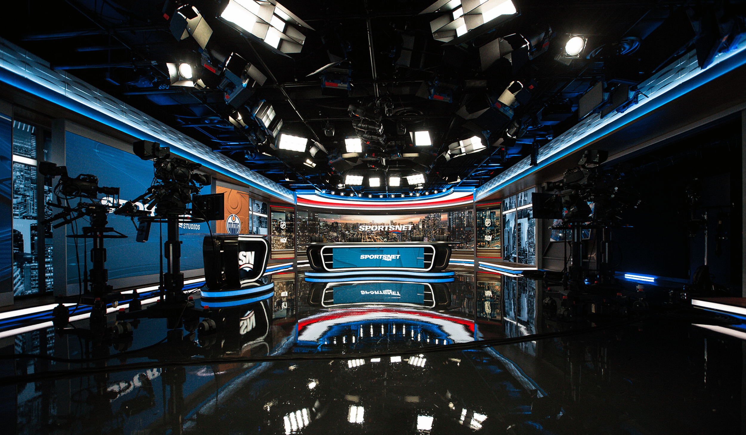 Sportsnet tv broadcast production studio showing the studio set with desks, screens and professional lighting