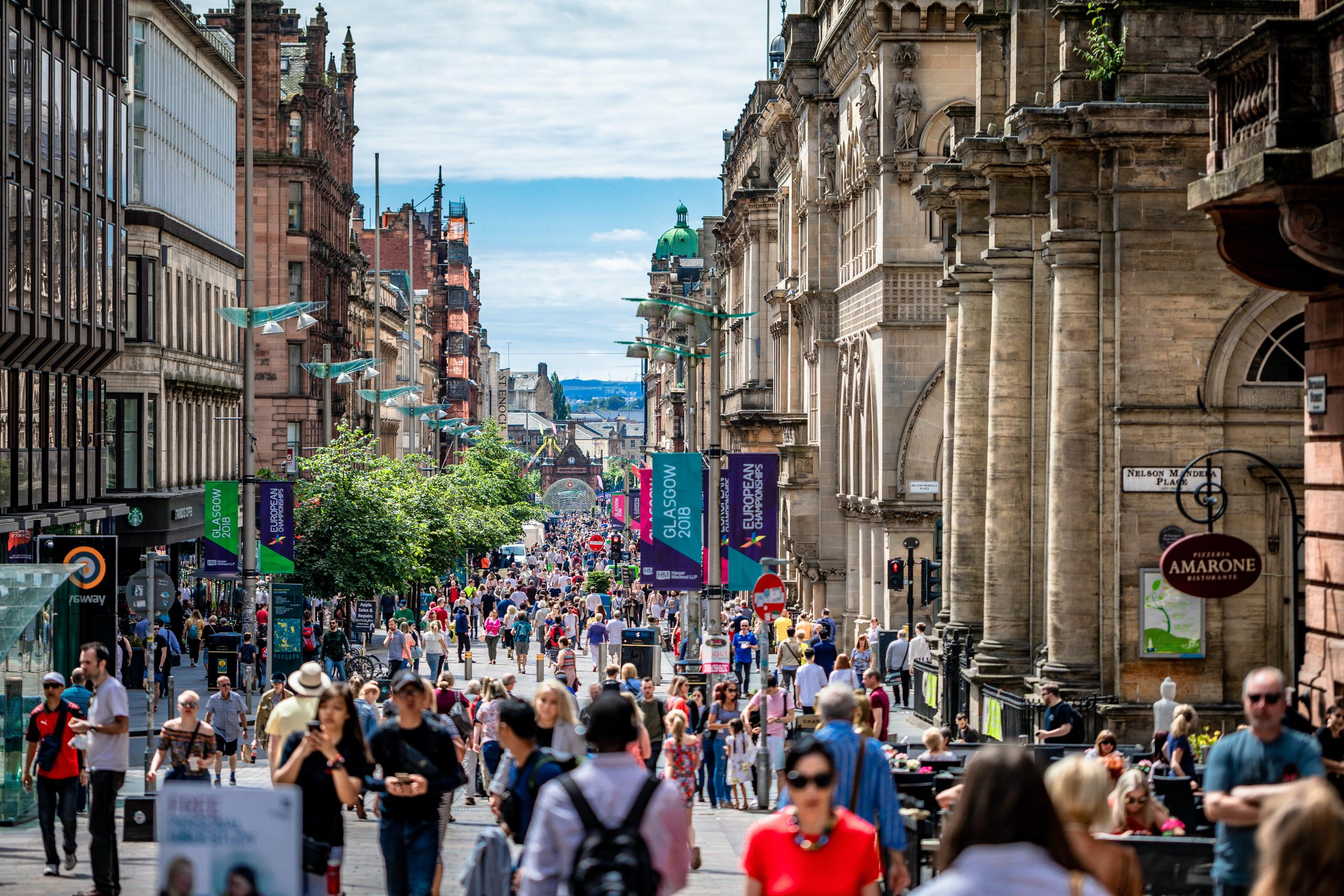 busy pedestrian-only retail high street in the UK