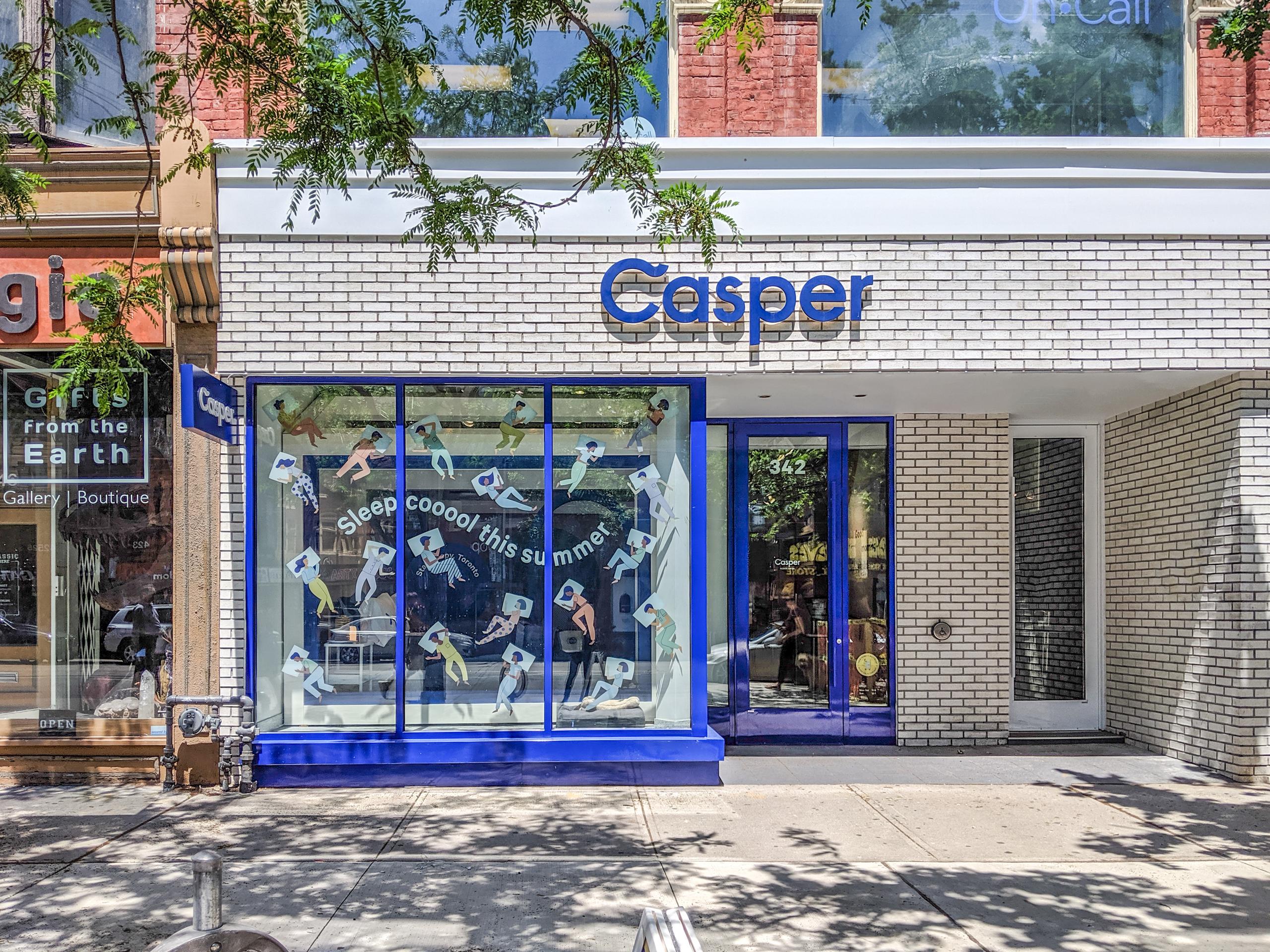 Casper mattress company streetfacing storefront with white brick and blue framing