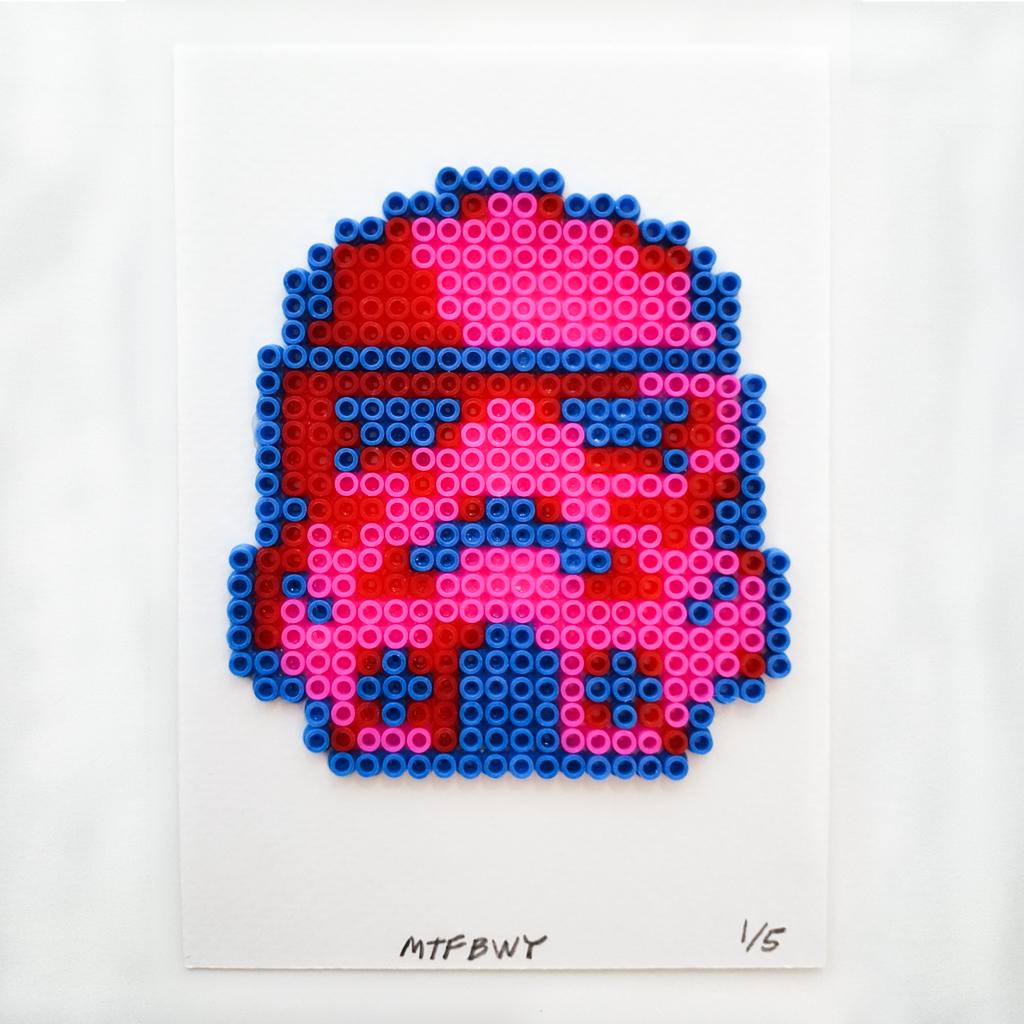 a pink and blue stormtrooper helmet made of rubber beads