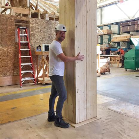 Jeff Hull hugging a wooden beam 