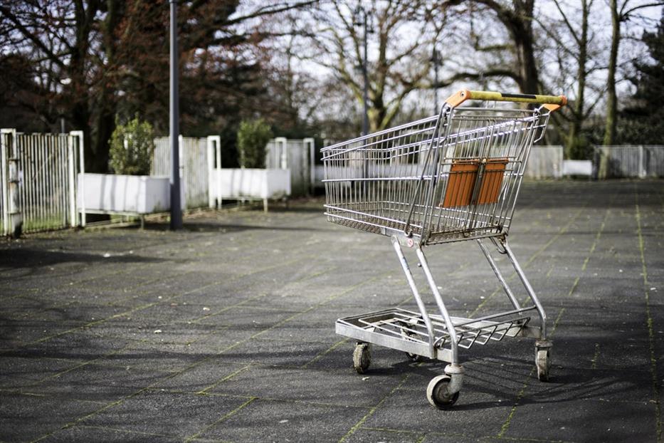 a shopping cart left in an empty parking lot