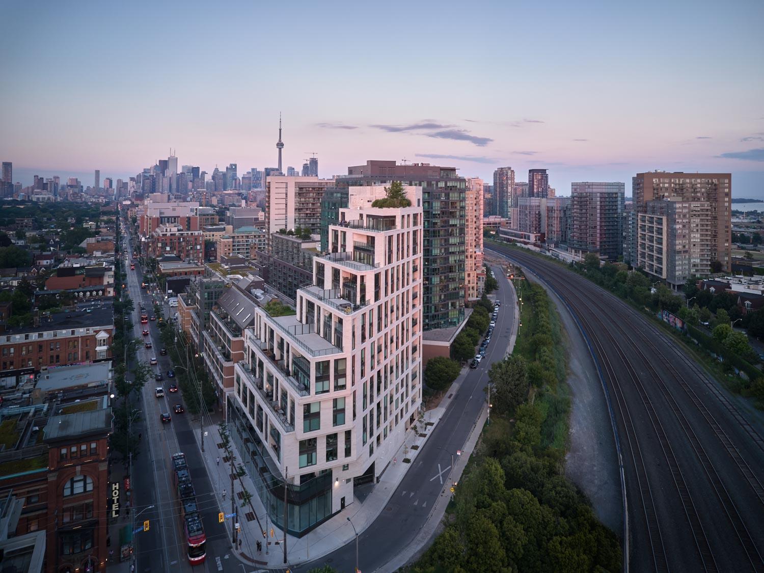 Aerial rendering of a condo building across the street from the Gladstone Hotel, showing the  uniquely angled facade and stepped balconies.