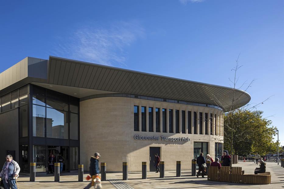 front exterior of Gloucester Transport Hub, with a light brick curved facade and modern glazed entrance volume